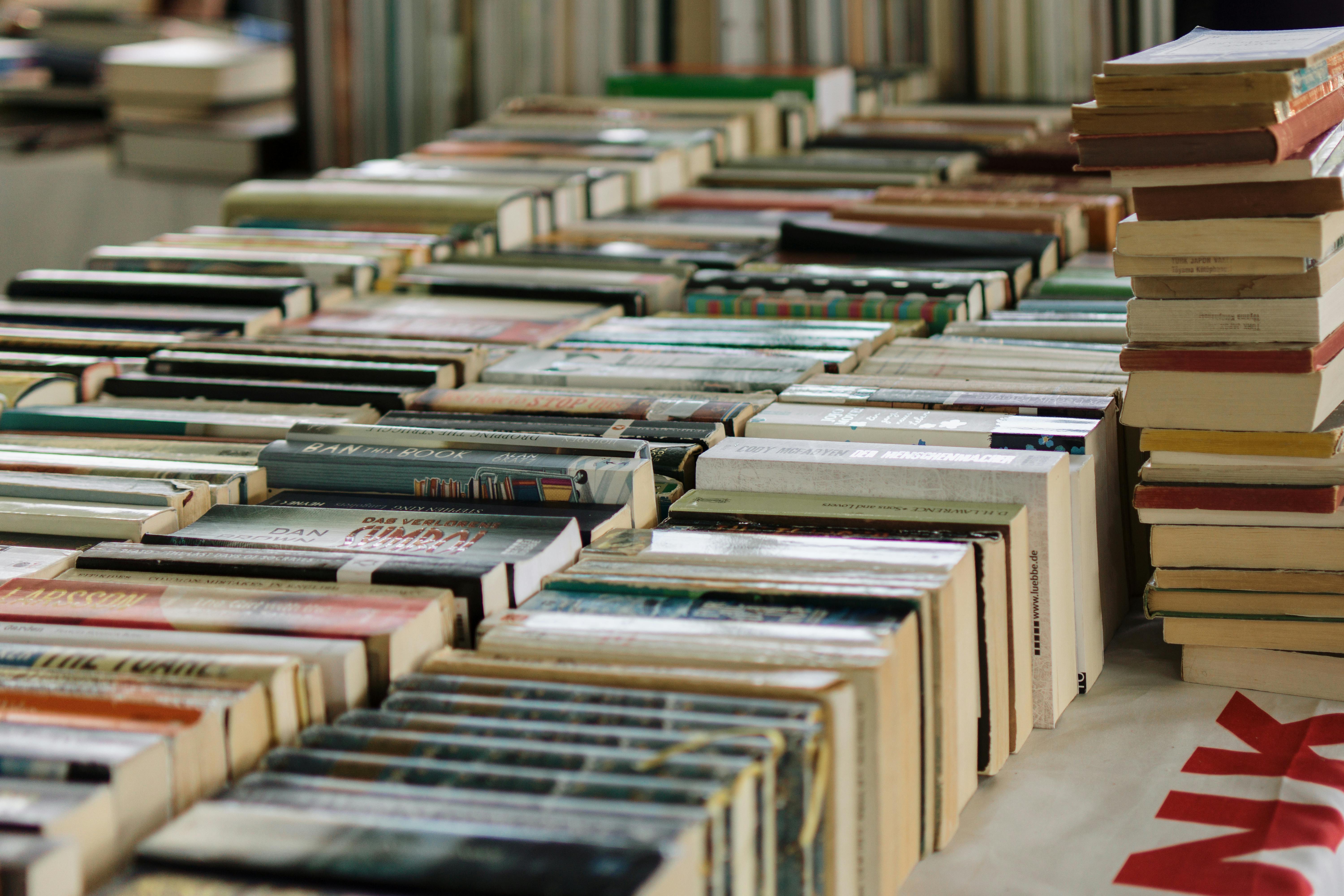 Stacks of books arranged across long tables