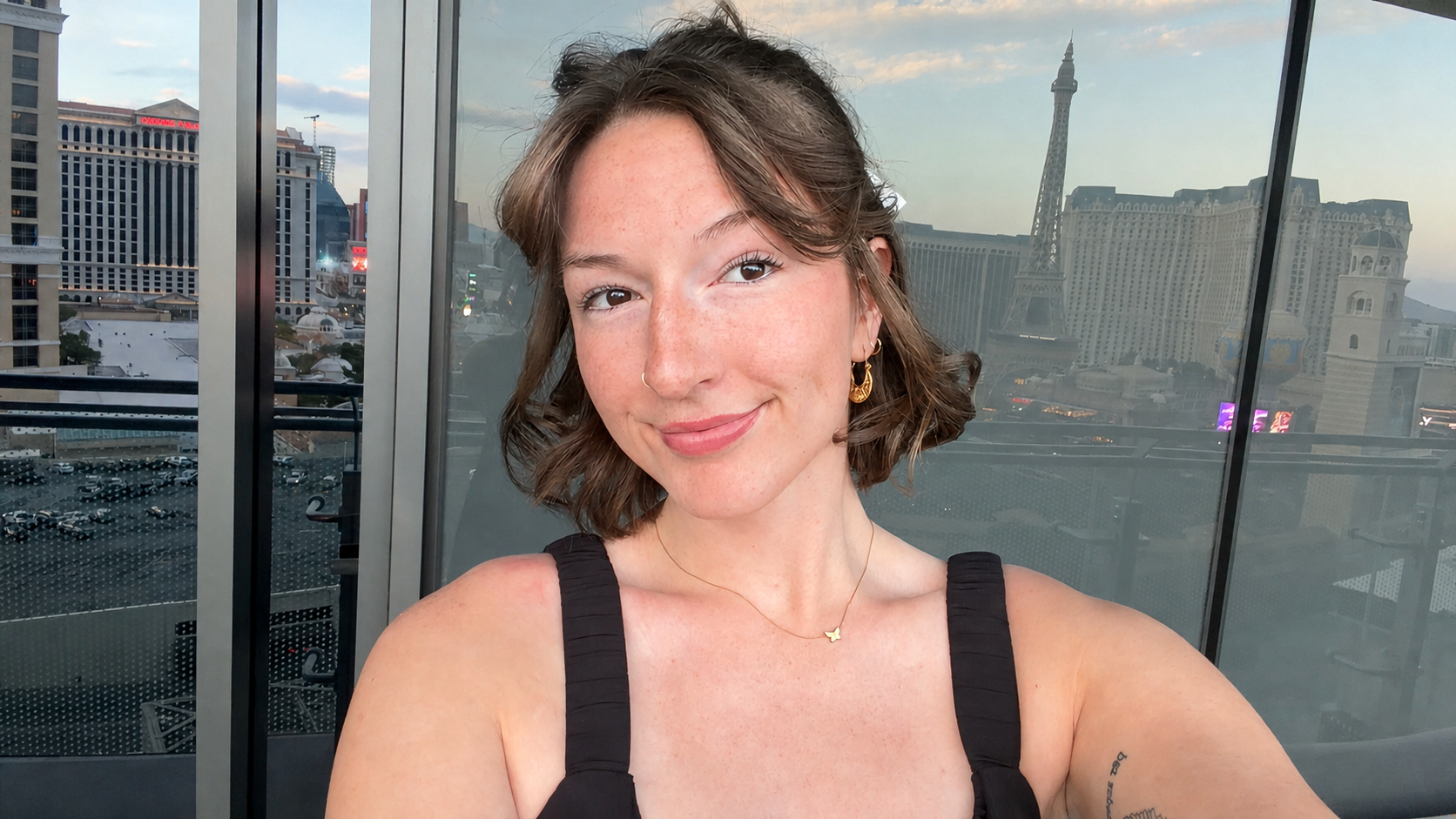 Mackenzie E. smiling with the Las Vegas skyline behind her