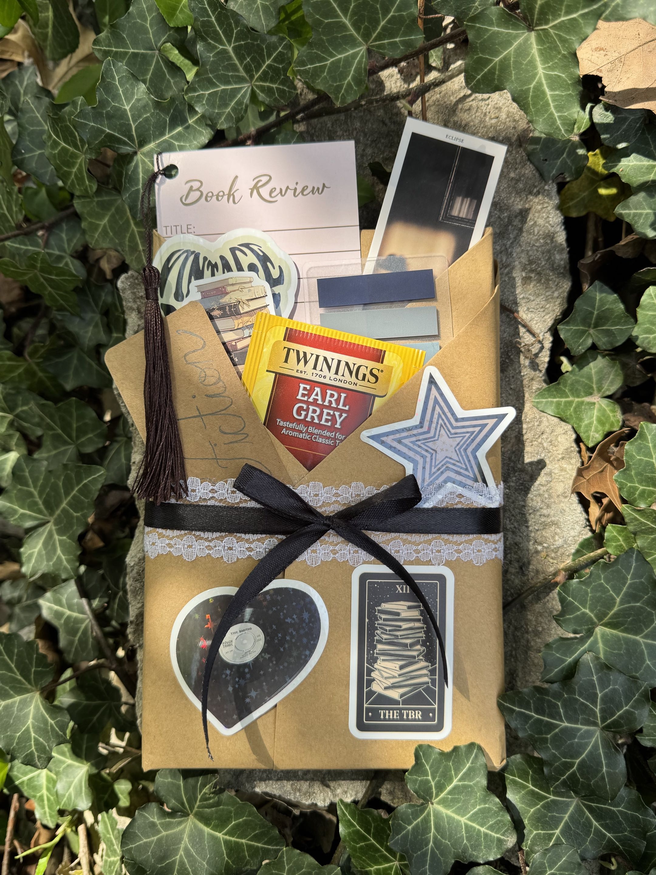 Wrapped book package styled with tea, ribbon, and decorative inserts